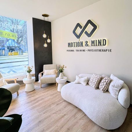 Heller, moderner Empfangsbereich mit Sitzgelegenheiten und dem Logo "Motion & Mind".